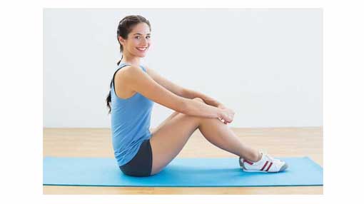 woman with shoes on yoga mat